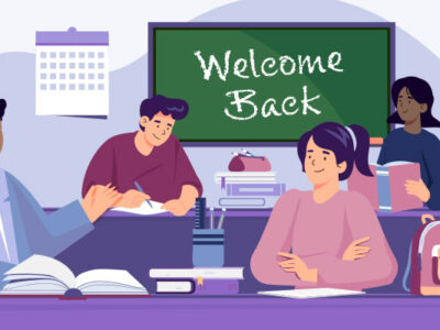 Students in classroom with Welcome Back written on chalkboard
